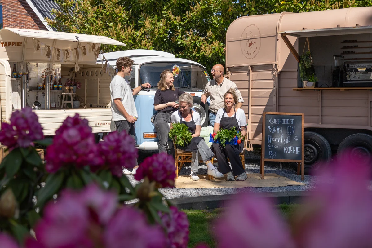 Gasten genieten van koffie en hapjes bij de foodtrucks van Veluwsche Overvloed